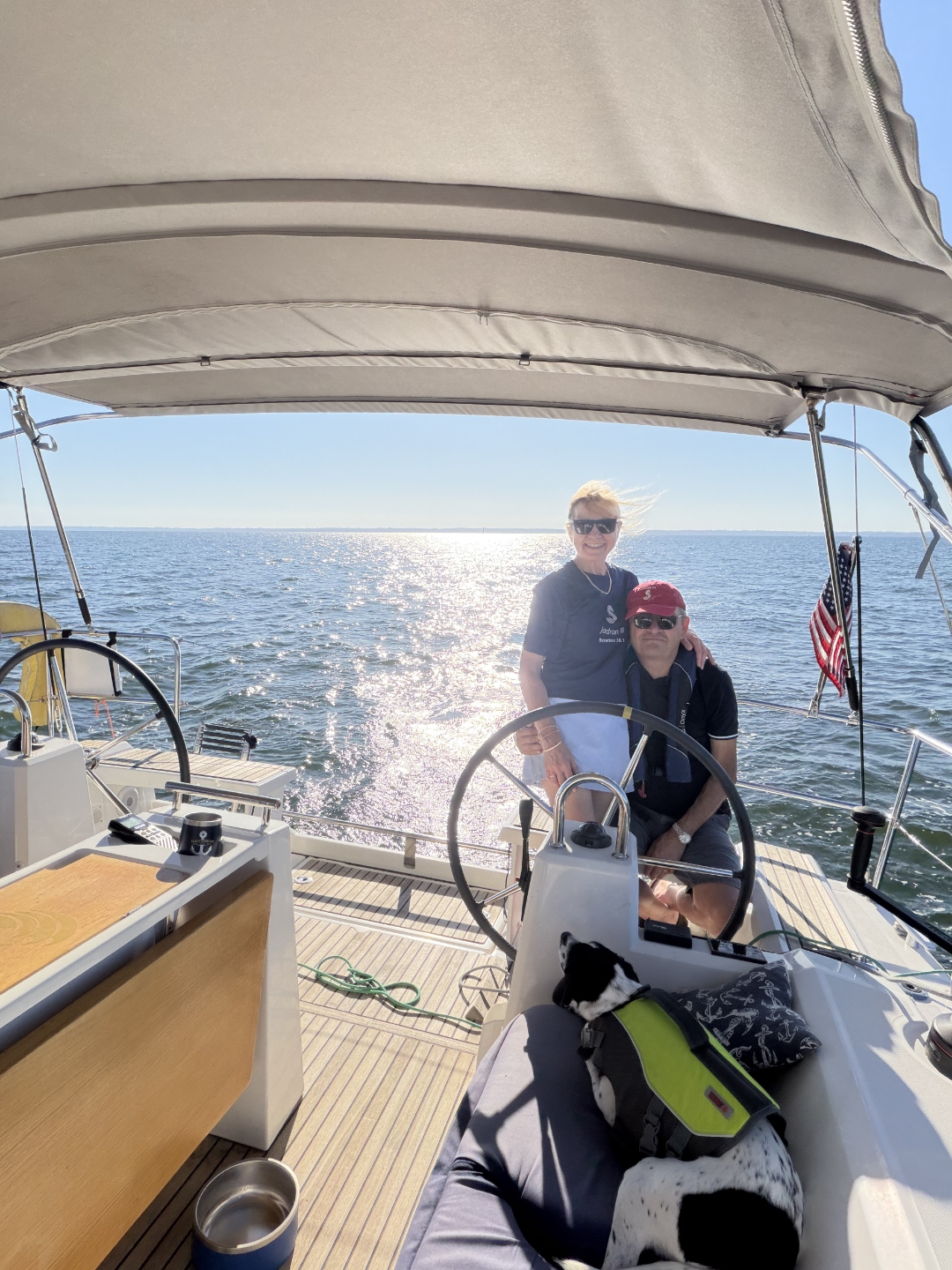 Couple at the helm with their dog